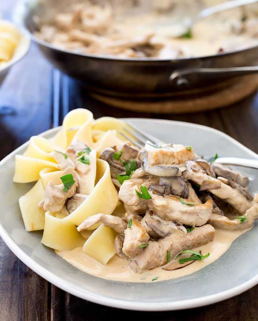 Easy Weeknight Dinner Recipes. Noodles with mushrooms and sauce on a plate with parsley.