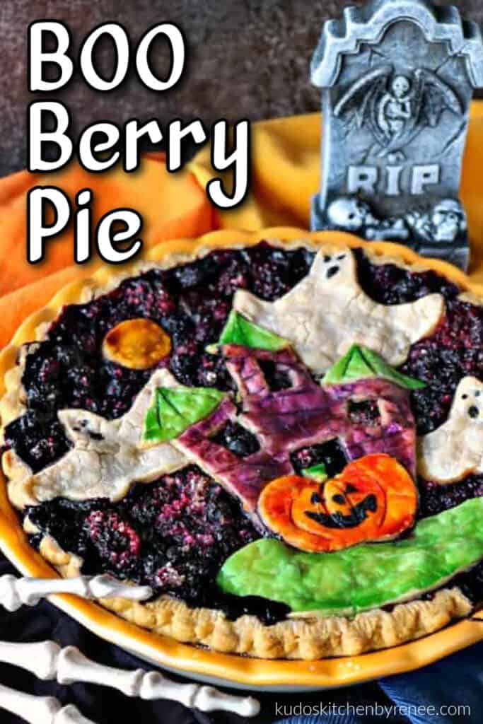 A closeup colorful Boo Berry Pie with painted haunted house and ghosts pie crust.