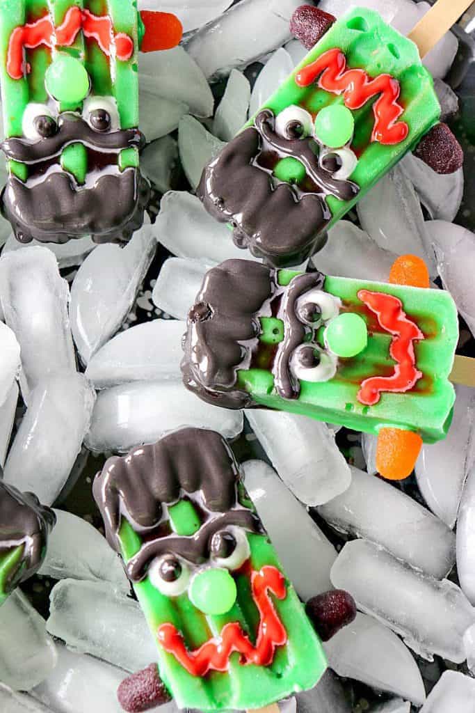 An overhead vertical image of frozen Halloween pops with scary faces.