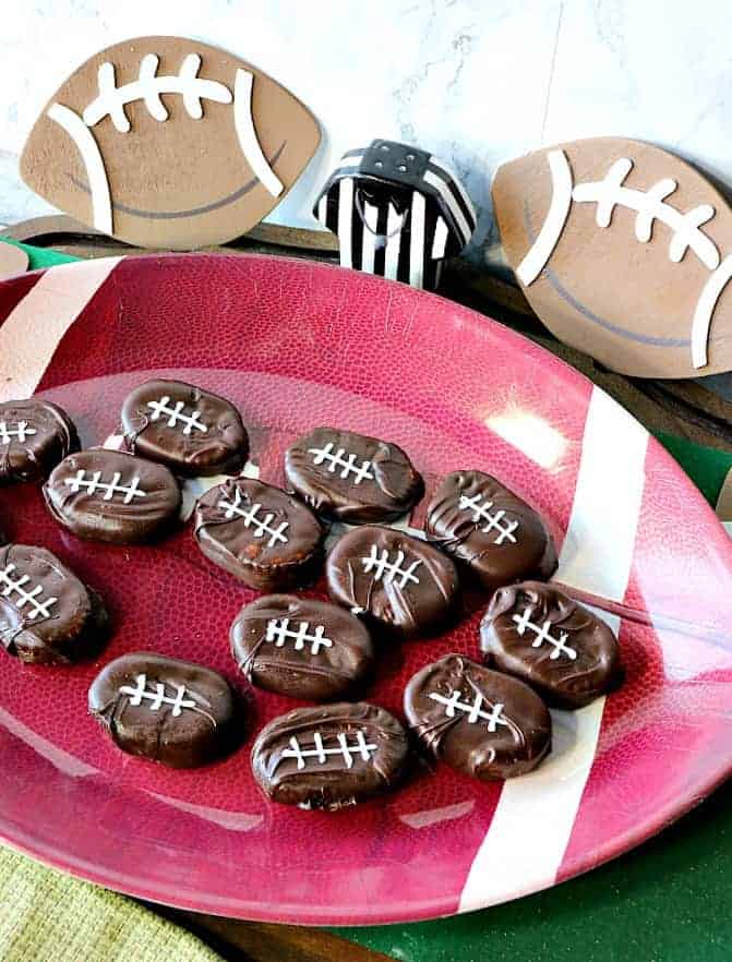 On overhead photo of a tray of chocolate covered football crackers.