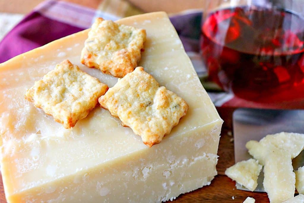 Golden Crispy Parmigiano-Reggiano Parmesan Fennel Crackers with a glass of wine.