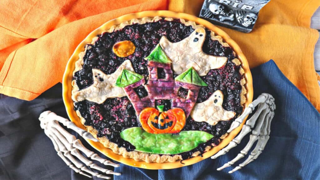 A Boo Berry Pie with skeleton hands and a fun Halloween painted pie crust