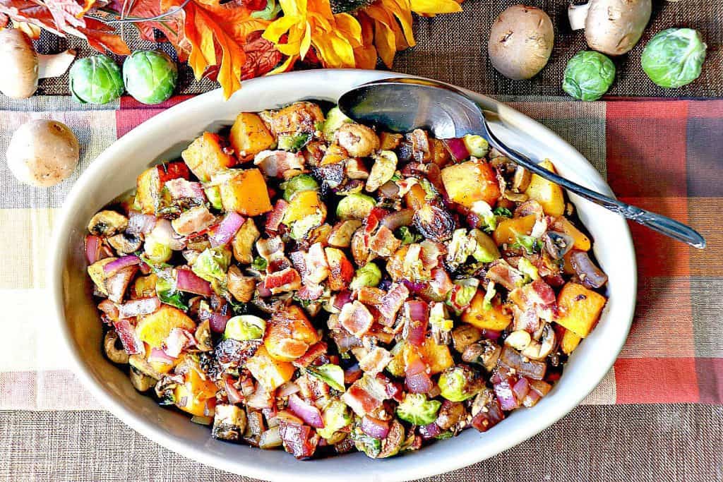 Overhead photo of Thanksgiving vegetables in an oval dish with a serving spoon and a fall colored napkin.