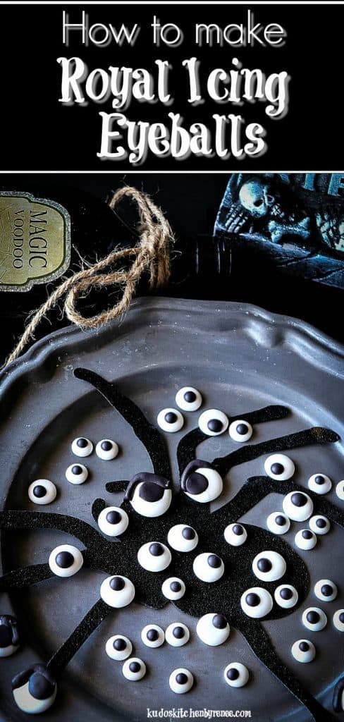 A vertical photo of Homemade Candy Eyeballs on a pewter plate with a spider silhouette. 