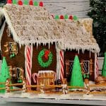 A fully decorated Gingerbread house complete with pretzel fence, candy cane pillars, and ice cream cone trees.