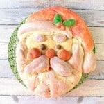 A cute Buttermilk Santa Shaped Bread with holly berry and a cap.