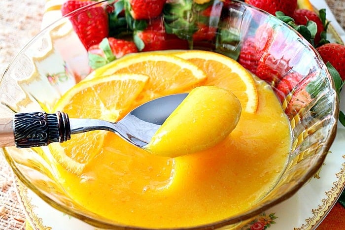 Closeup picture of a spoonful of homemade orange curd.