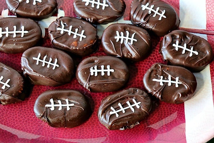 Overhead photo of a tray of chocolate covered football crackers. Easy chocolate dessert recipes roundup.