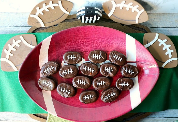 Overhead shot of Peanut Butter and Jelly Chocolate Footballs on a football platter with a green placemat