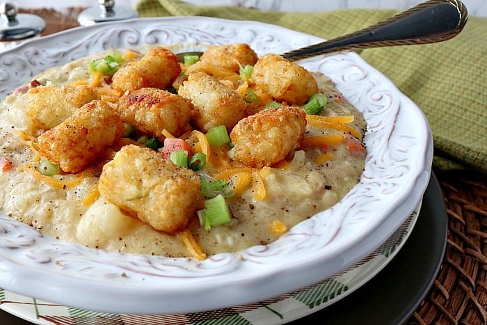 Gluten-Free Tater tot chowder in a white filigree bowl with a spoon and a green napkin.