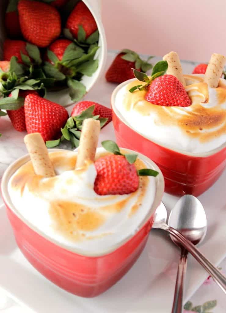 Baked Alaska for Two with a bucket of spilled strawberries and two spoons.