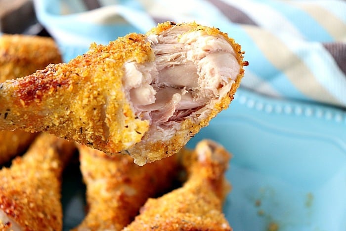 Air fryer chicken drumstick with a bite taken out.