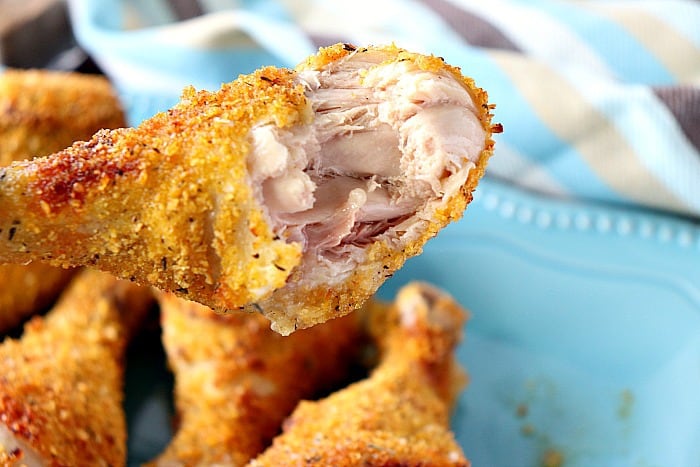 Air fryer chicken drumstick with a bite taken out.