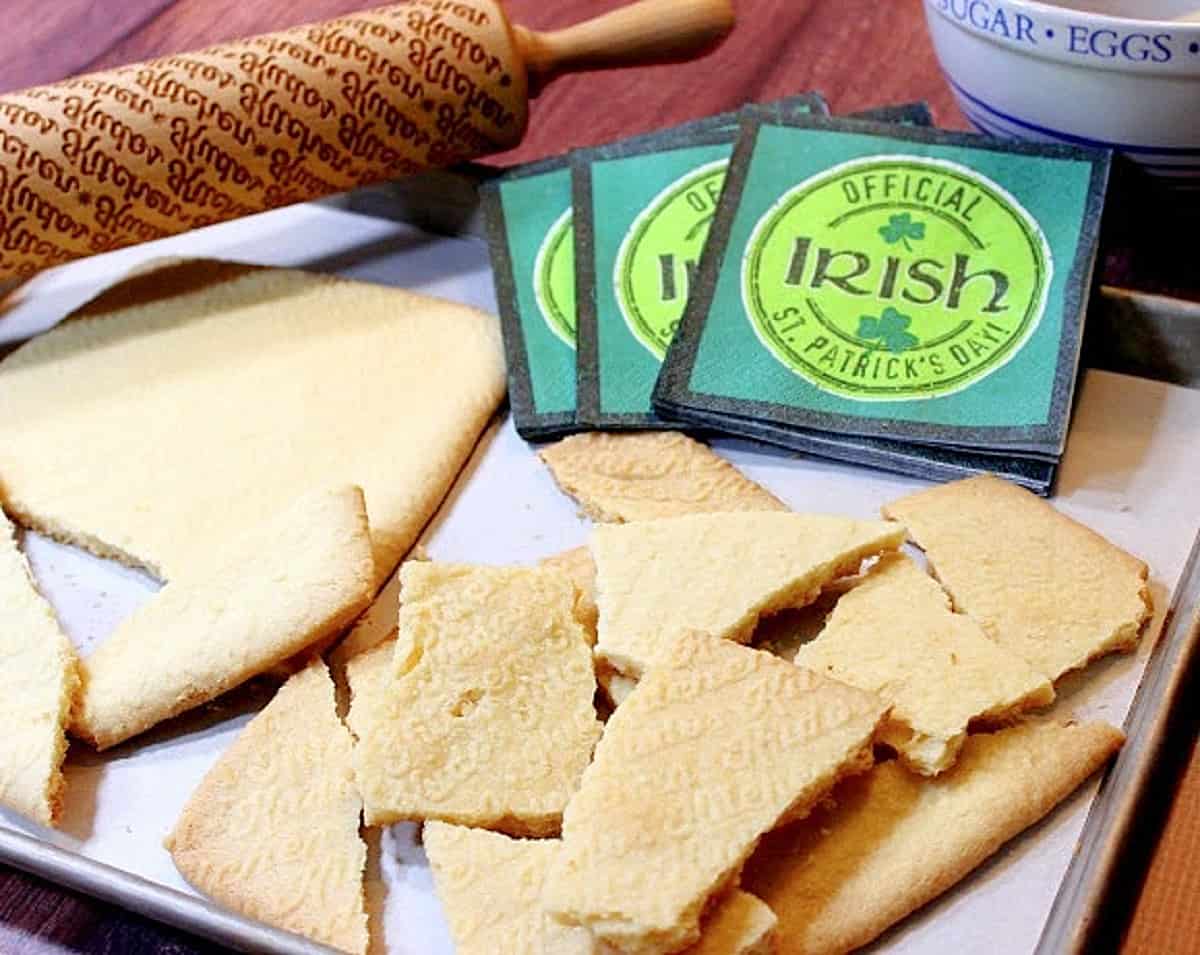 Some pieces of broken Irish Shortbread on a baking sheet with napkins.