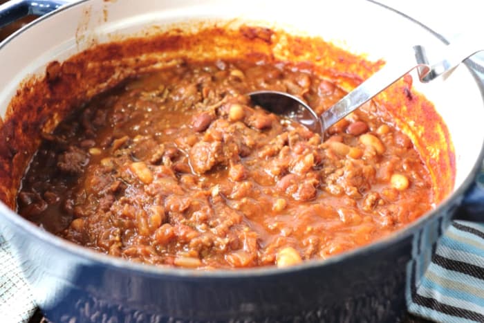 Pot of Microwave spaghetti squash chili with a ladle.