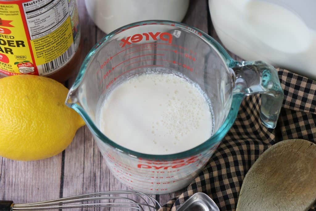 An overhead photo of homemade buttermilk in a glass measuring cup.