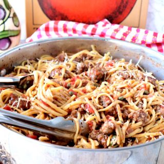 A silver skillet filled with One Pot Linguine with Sausage and Capers.