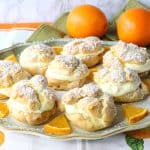 Plate of profiteroles with oranges and orange segments