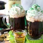 Two cups of Traditional Irish Coffee topped with whipped cream and green sugar.