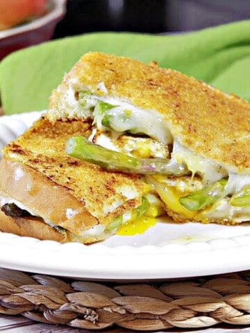 A Breakfast Grilled Cheese Sandwich on a white plate with a green napkin in the background.
