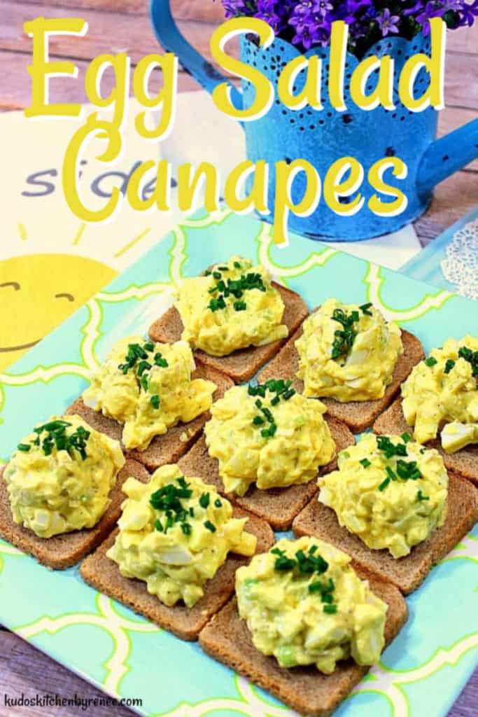 A vertical closeup image of Egg Salad Canapes on a blue and yellow plate with a title text overlay graphic.