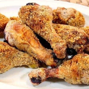 A bunch of Breaded Baked Italian Chicken Legs on a plate.