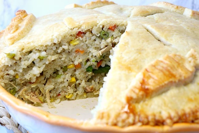 Closeup photo of Chicken and Rice Pot Pie with a slice taken out.