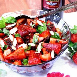Strawberry basil salad in a glass bowl.