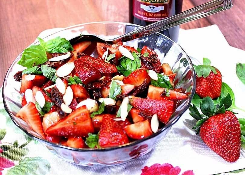 Strawberry basil salad in a glass bowl.