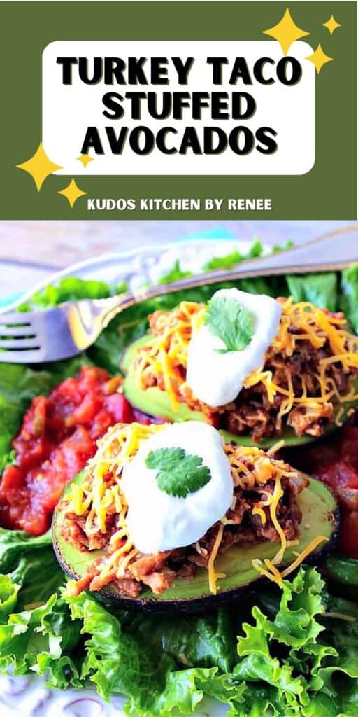 Two Turkey Taco Stuffed Avocados on a plate along with cheese, sour cream, and cilantro.