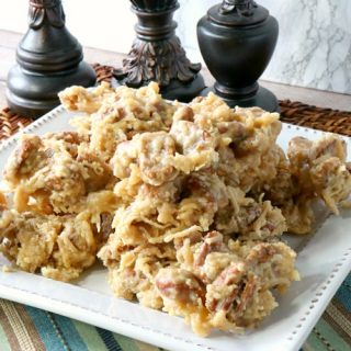 Square plate piled high with coconut pecan praline candy.