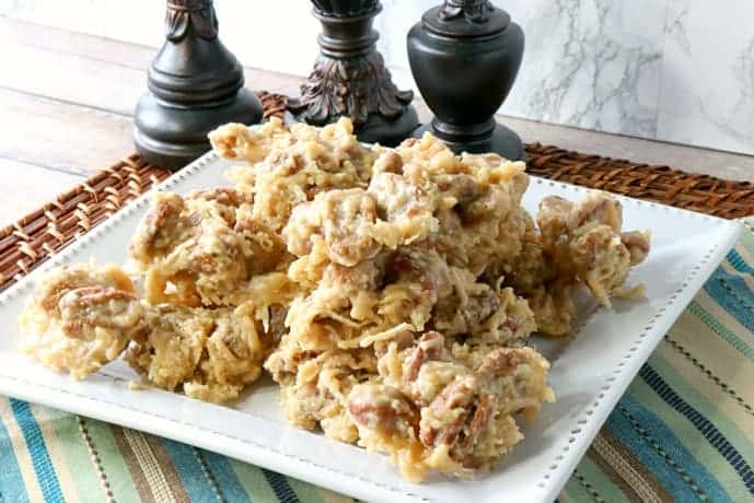 Square plate piled high with coconut pecan praline candy.