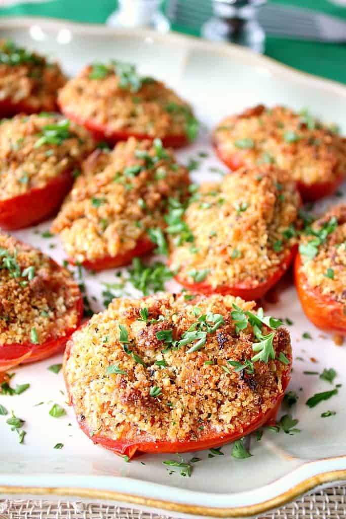 Italian Roasted Plum Tomatoes - kudoskitchenbyrenee.com Closeup photo of a plate of Italian roasted plum tomatoes with breadcrumbs and Parmesan cheese.