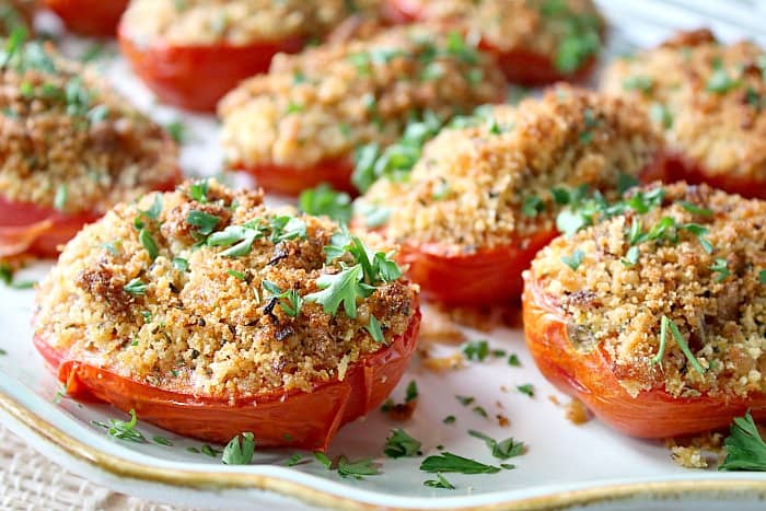 A closeup horizontal photo of Italian Roasted Plum Tomatoes with breadcrumbs and parsley.