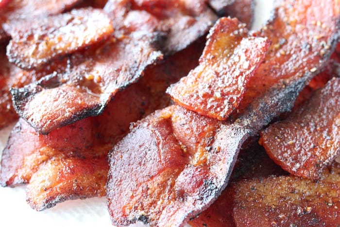 Closeup photo of a stack of air fryer fried bacon.