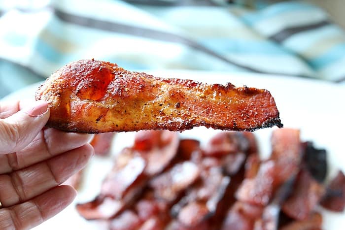 A closeup piece of crisp bacon made in an air fryer.