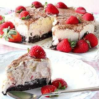 A slice of Neapolitan Ice Cream Cake in the forefront and an entire ice cream cake in the background.