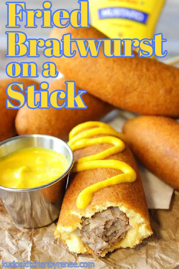 A closeup vertical photo of a fried bratwurst on a stick with yellow mustard and a title text overlay graphic