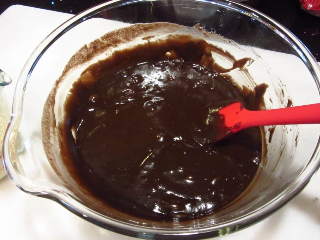 The batter for a chocolate cherry Bundt cake in a glass bowl.