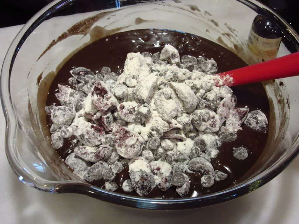 Cherries and chocolate chips added to a chocolate batter to make a Bundt cake.