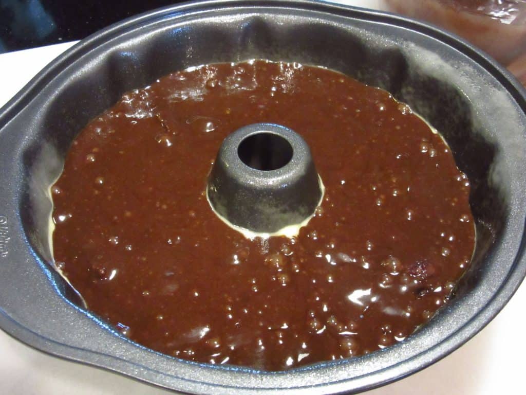 The batter for a chocolate Bundt cake in a Bundt pan before baking.