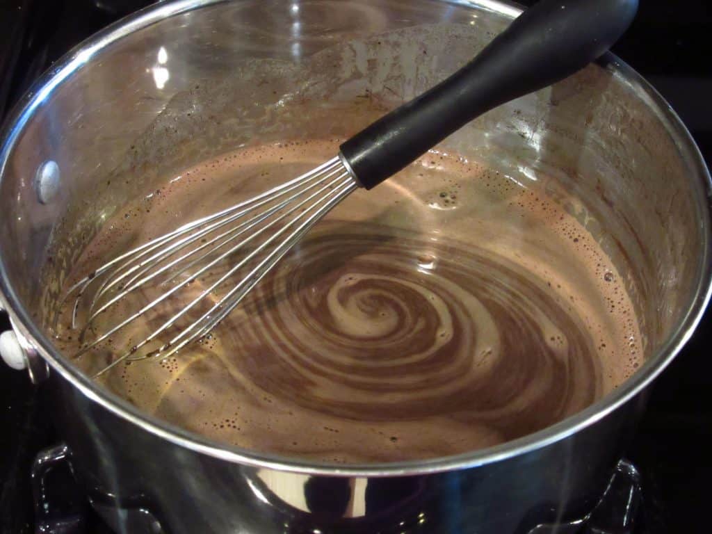 Melted chocolate and butter in a saucepan with a whisk.