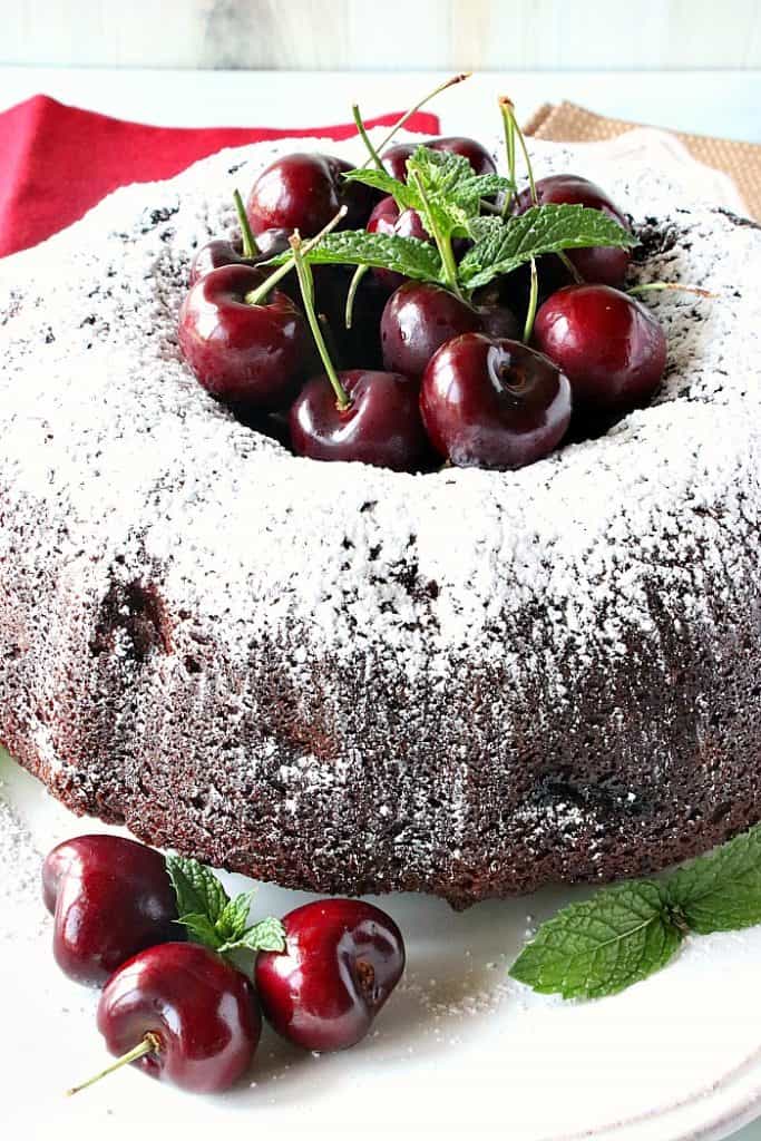 A chocolate cherry bundt cake dusted with confectioners sugar and stuffed full of fresh cherries.