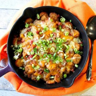 Overhead photo of a skillet filled with tater tot poutine.