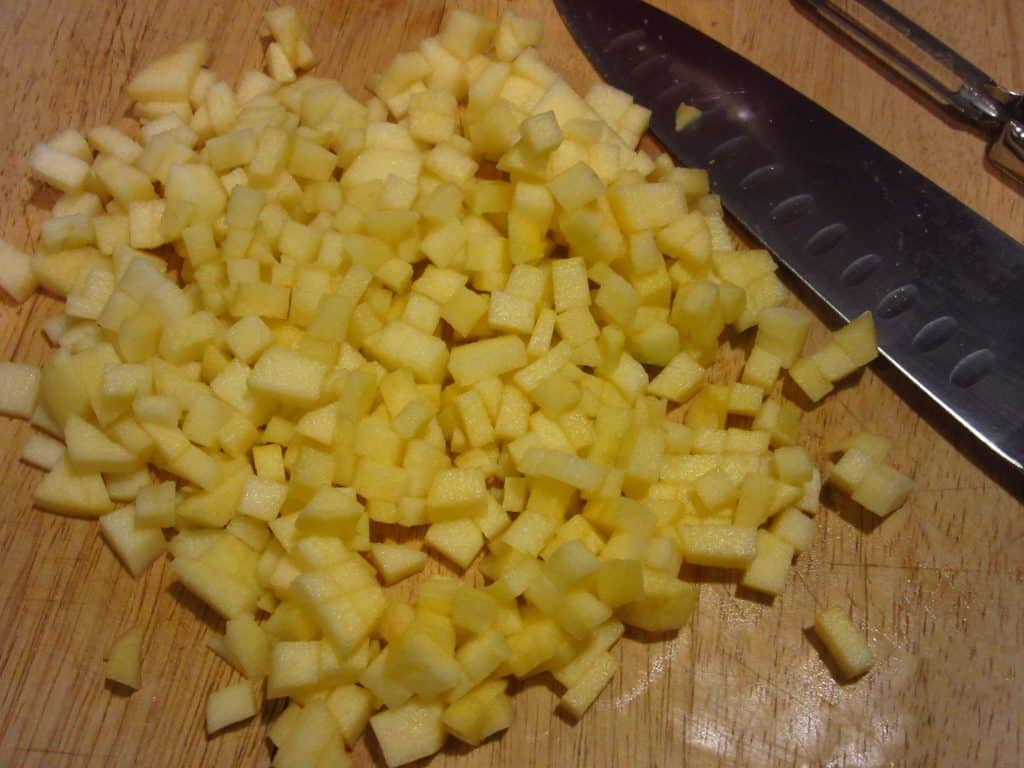 Diced apples on a cutting board.