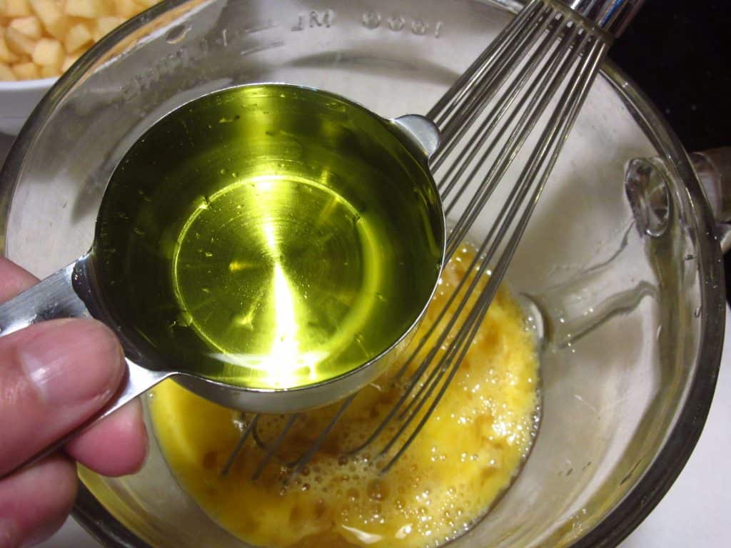 Oil being added to a glass bowl.