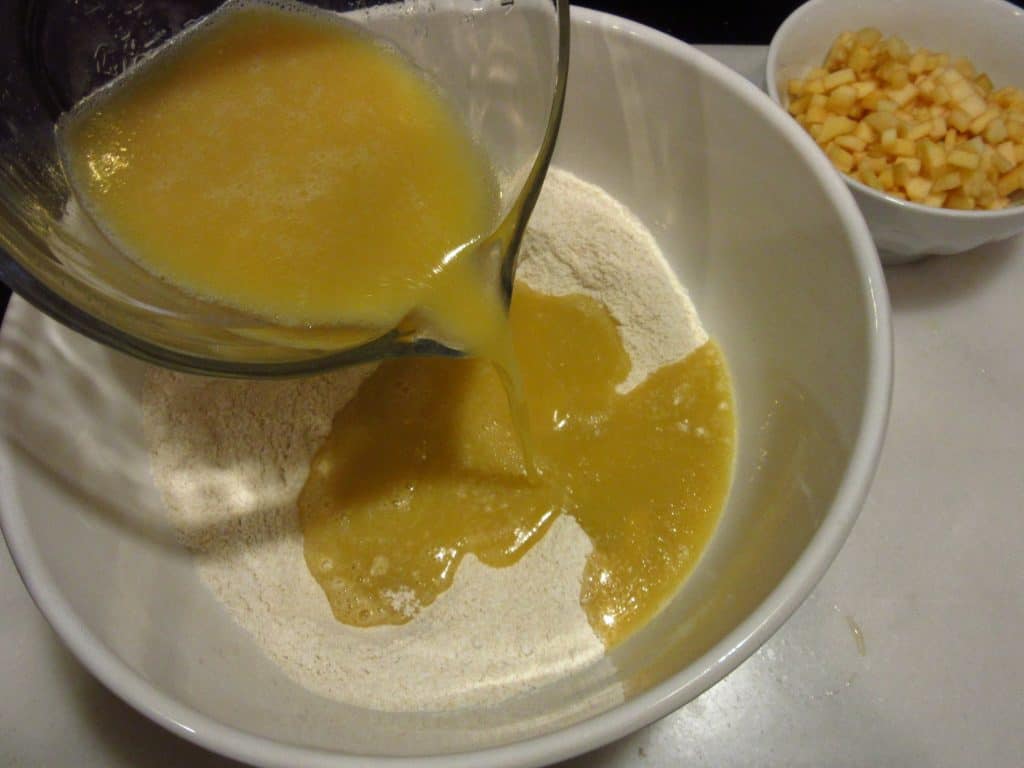 A liquid mixture being added to dry ingredients.