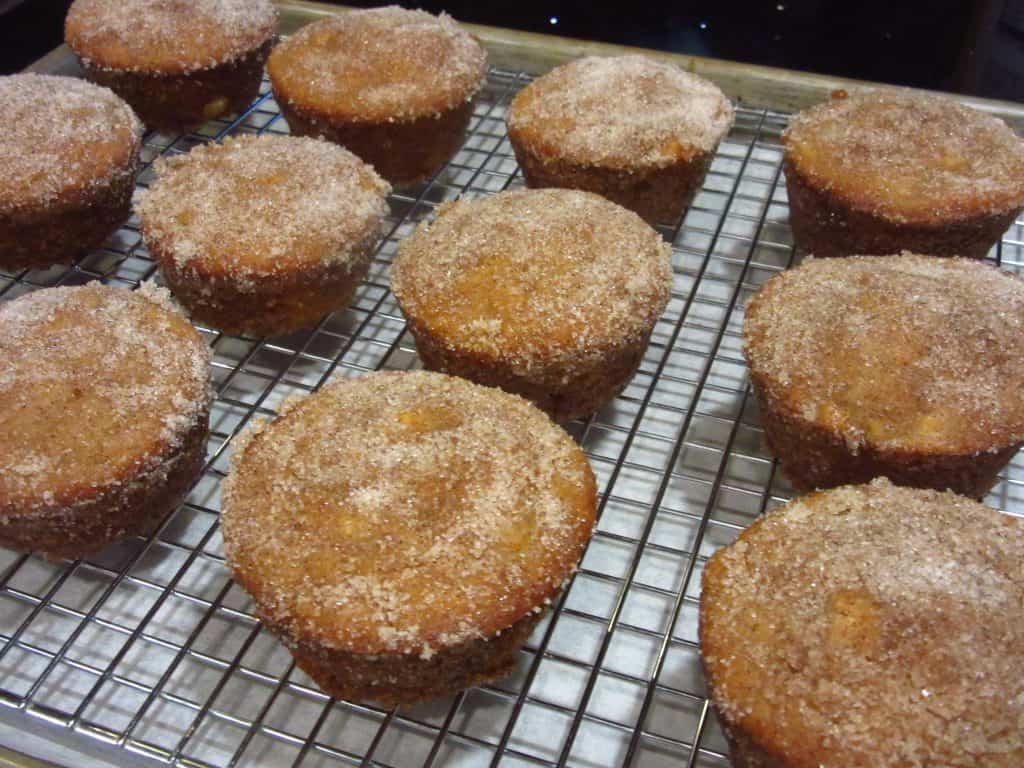 Apple cider donut muffins on a cooling rack.