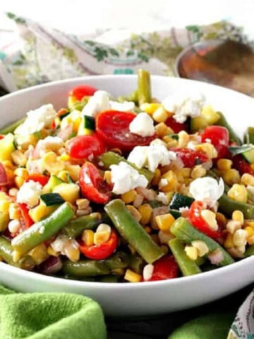 A white bowl filled with a colorful Farmer's Market Vegetable Salad.