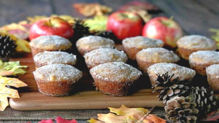 Apple Cider Donuts On A Wood Tray With Apples And Pine Cones